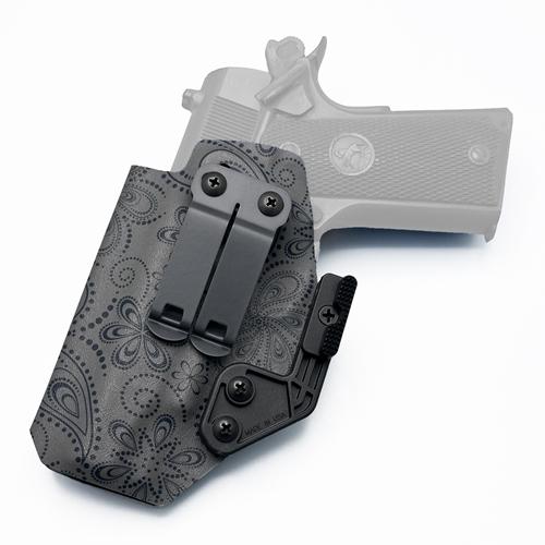 Left-handed IWB KYDEX holster for Colt 1911 Commander featuring a dark gray paisley floral pattern, equipped with a DCC Monoblock gear clip and Modwing concealment claw.