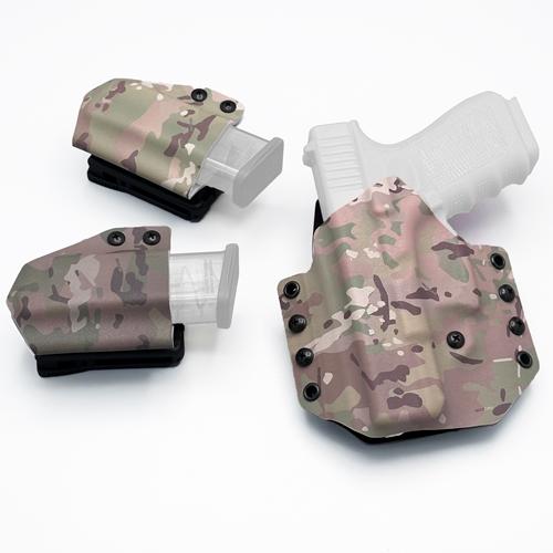 A complete left-handed OWB KYDEX holster setup for a Glock 19 in a Multicam camouflage pattern, featuring two matching KYDEX Single magazine carriers.