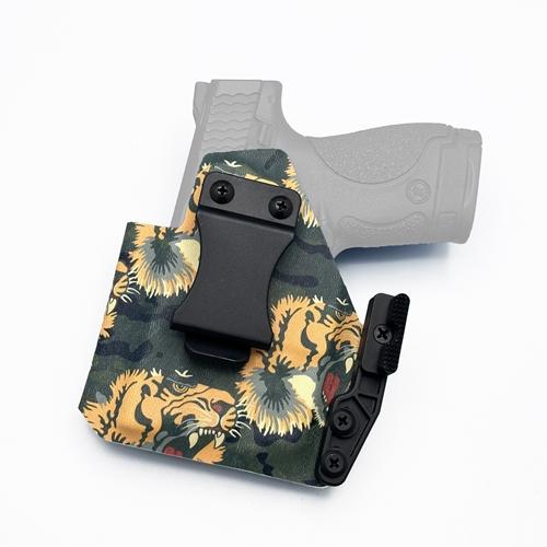 left-handed IWB KYDEX holster for a Smith & Wesson M&P 9 Shield with Streamlight TLR-6, featuring a Quick Clip, and Modwing concealment claw.