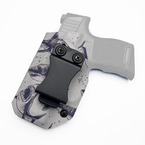 left-handed IWB KYDEX holster for a Sig Sauer P365, featuring a great white shark illustration pattern and a FOMI clip.