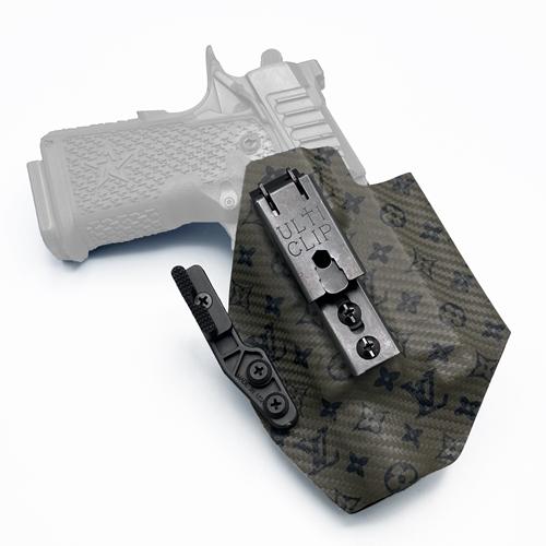 inside the waistband KYDEX Staccato C2 Surefire X300U holster featuring a dark monogram pattern, equipped with an UltiClip XL and a Light-Bearing Modwing concealment claw.